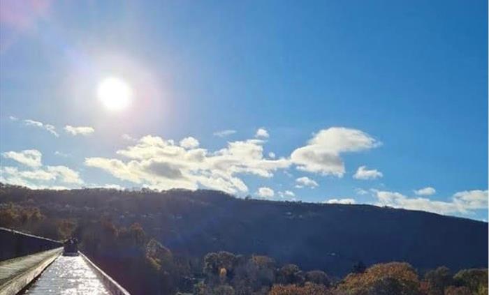A view of the beautiful tree tops and the blue sky sunny sky from the iconic Pontcysyllte Aqueduct.